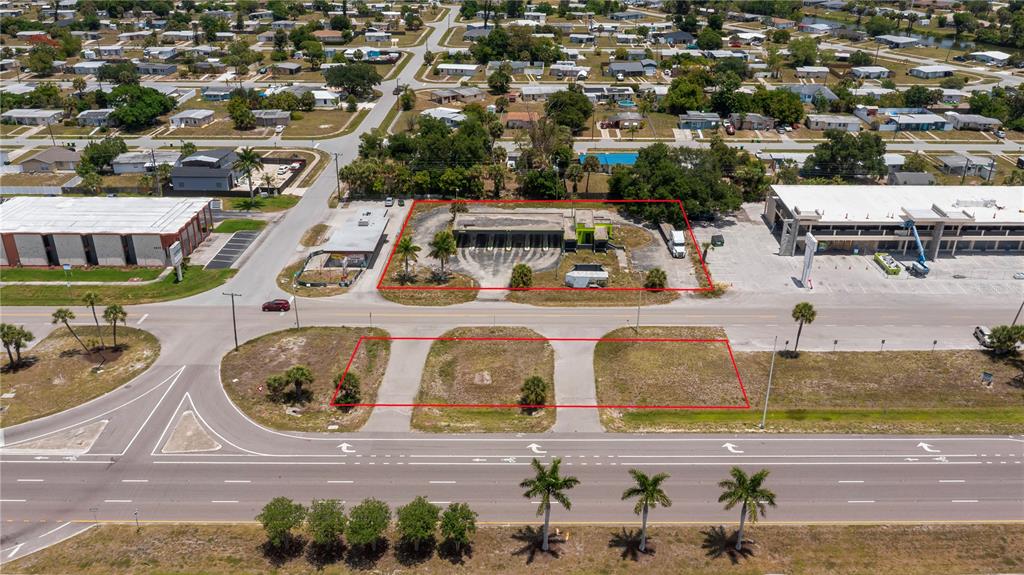 An aerial view shows a vacant commercial lot with a former gas station building — 3570 TAMIAMI TRAIL, PORT CHARLOTTE, FL