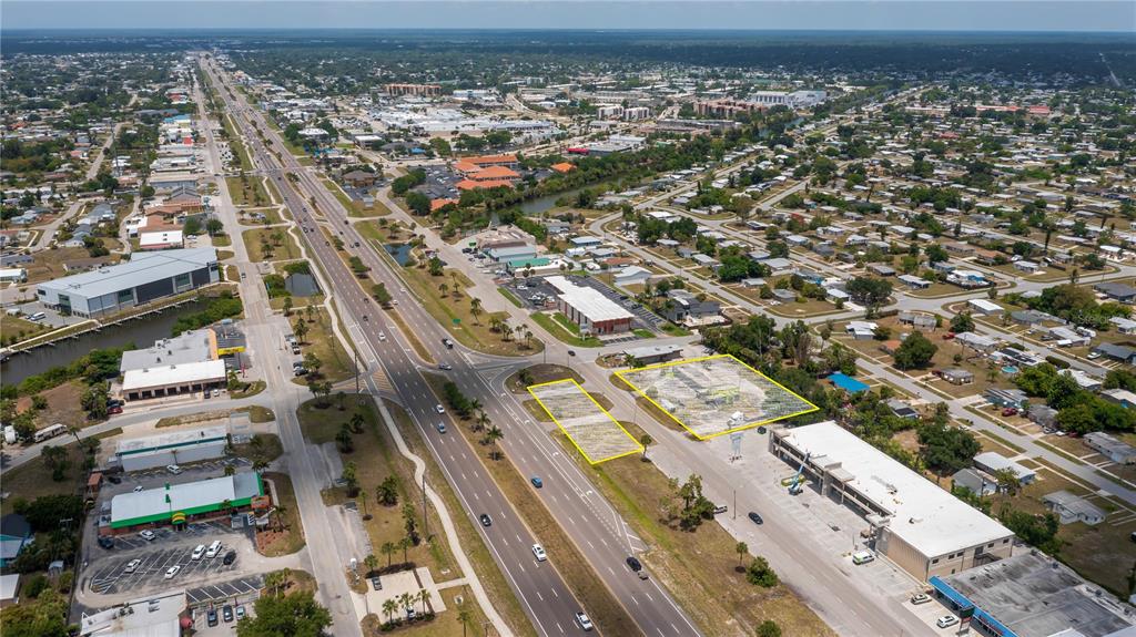 An aerial view shows two vacant lots highlighted in yellow along a multi-lane highway — 3570 TAMIAMI TRAIL, PORT CHARLOTTE, FL