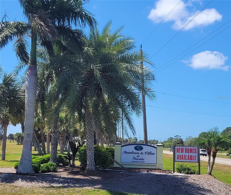 A sign for Meadows & Villas at Placida stands near palm trees and a road — 13111 BLUE MARLIN ROAD, PLACIDA, FL