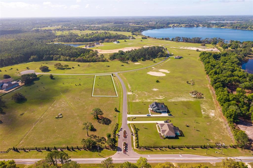 An aerial view shows a vacant residential lot outlined in white within a rural subdivision — 38529 WOODED MEADOW DRIVE, UMATILLA, FL