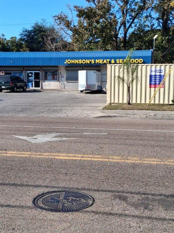 A commercial building with a blue roof and a sign reading Johnson's Meat & Seafood — 2748 W 45TH STREET, JACKSONVILLE, FL