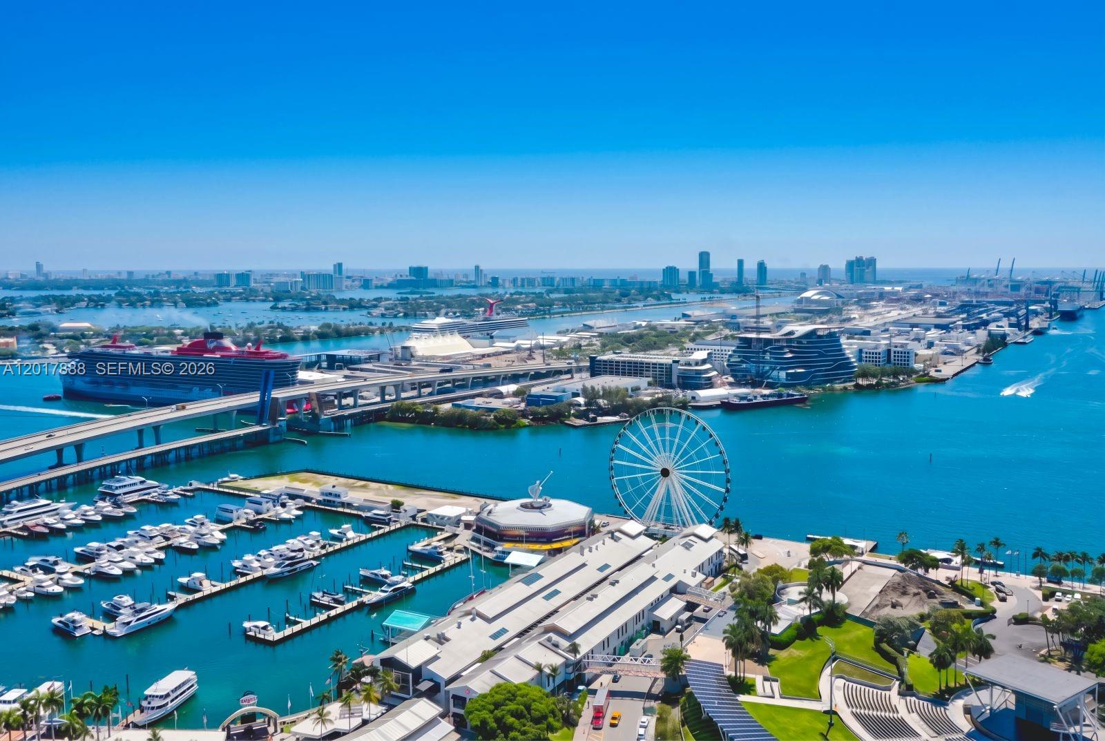 An aerial view shows a marina, a large Ferris wheel, and cruise ships in Miami — 244 Biscayne Blvd # 3602, Miami FL 33132, MIAMI, FL