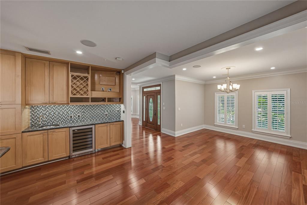A kitchen with light wood cabinets, dark granite countertops, and hardwood floors — 3001 W SAN RAFAEL STREET, TAMPA, FL