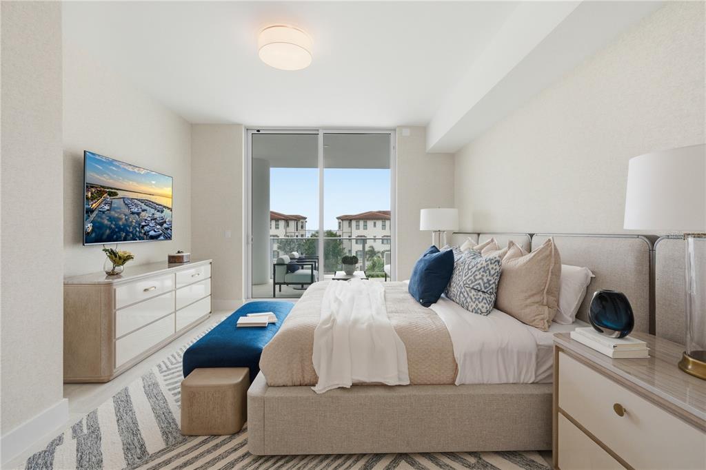 A modern bedroom features a king bed, a dresser, and a balcony with water views — 5713 BOWEN DANIEL DRIVE UNIT 402, TAMPA, FL