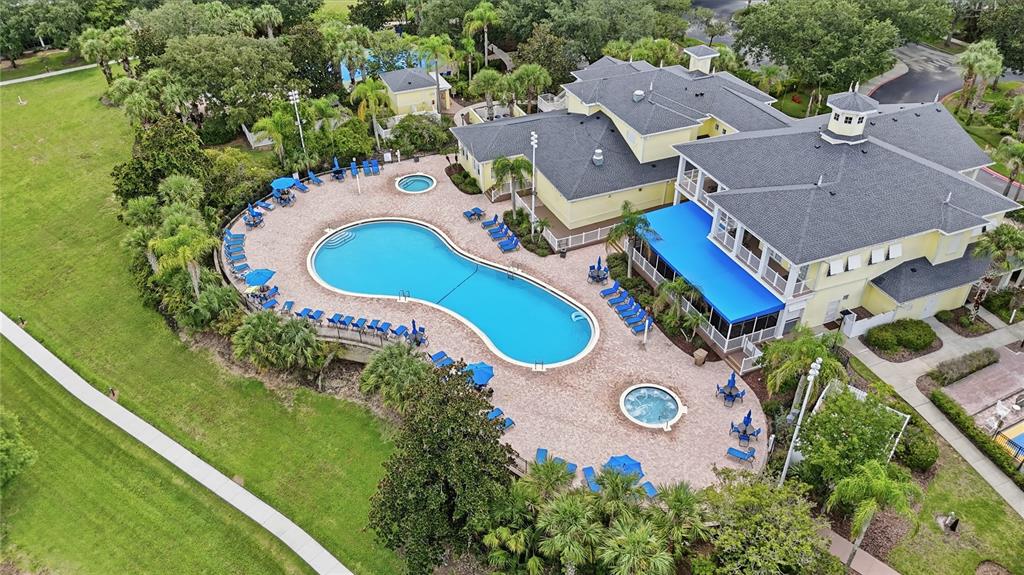An aerial view shows a community clubhouse with a swimming pool, hot tub, and patio — 1106 GRAN BAHAMA BOULEVARD UNIT 1106, DAVENPORT, FL
