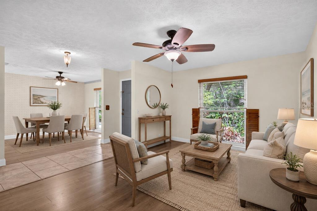 A living room and dining area with tile and wood flooring, ceiling fans, and furniture — 901 W RIVER DRIVE, TEMPLE TERRACE, FL
