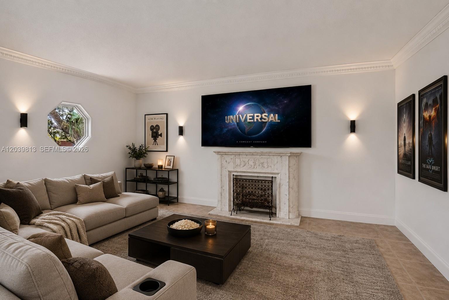 A living room features a fireplace with a mounted television, sectional sofa, and movie posters — 5511 Taylor St, Hollywood FL 33021, HOLLYWOOD, FL