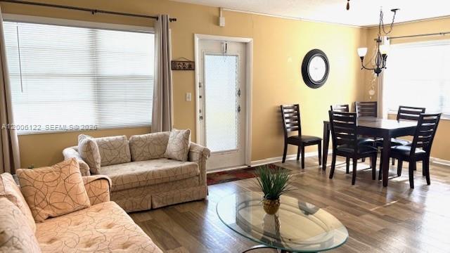 A living and dining area with a sofa, glass coffee table, and dark wood dining set — 1044 Harwood D # D, Deerfield Beach FL 33442, DEERFIELD BEACH, FL