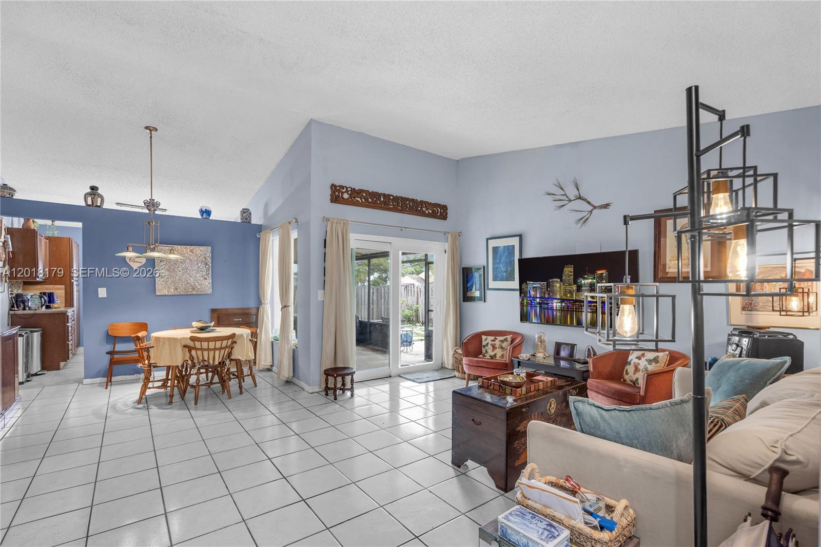An aerial view of a single-story house with a paved driveway and a palm tree — 19903 NW 67th Ct, Hialeah FL 33015, HIALEAH, FL