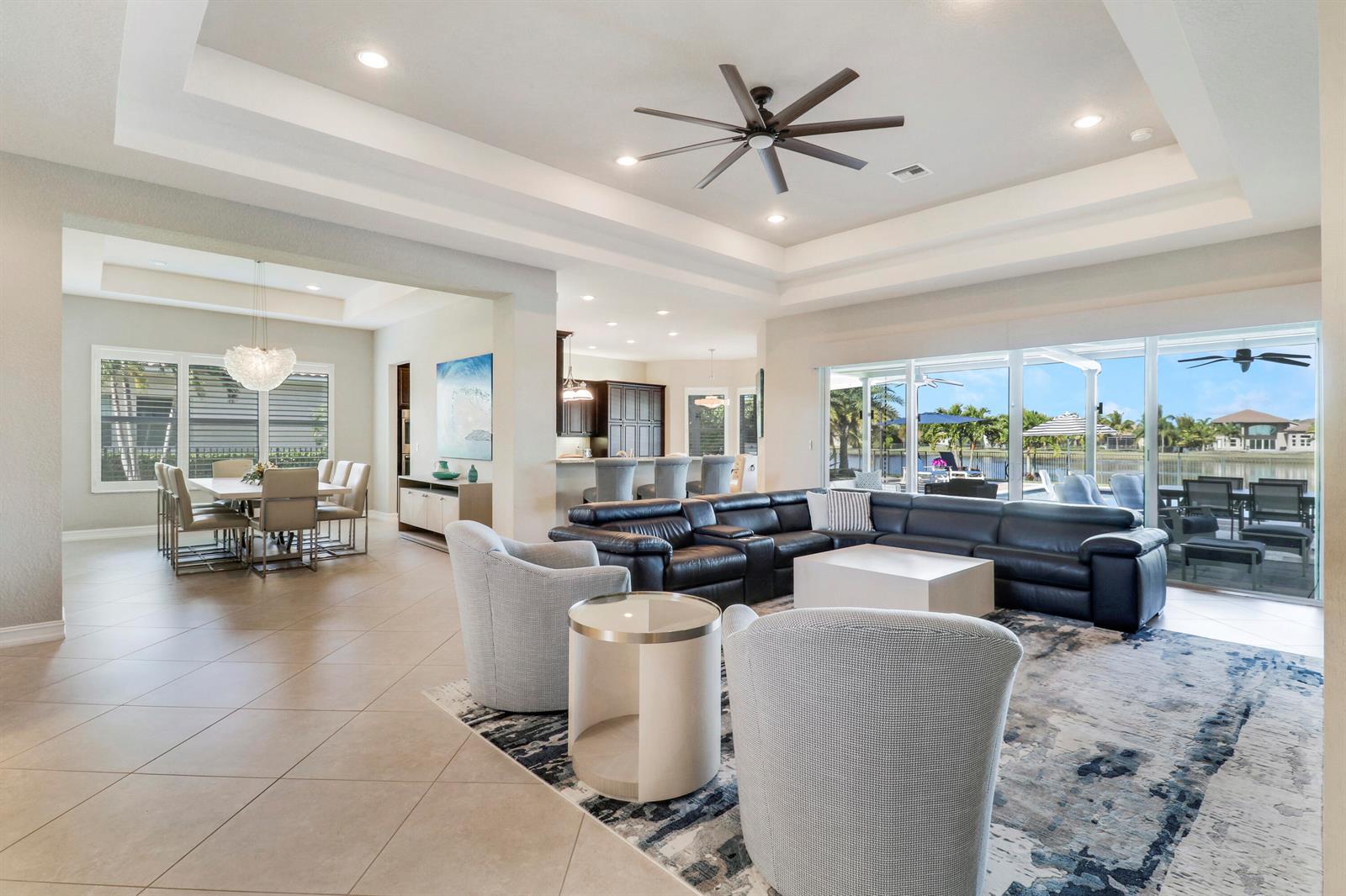 An open-concept living and dining area features tile floors, a coffered ceiling, and sliding glass doors — 7754 Maywood Crest Drive, West Palm Beach FL 33412, WEST PALM BEACH, FL