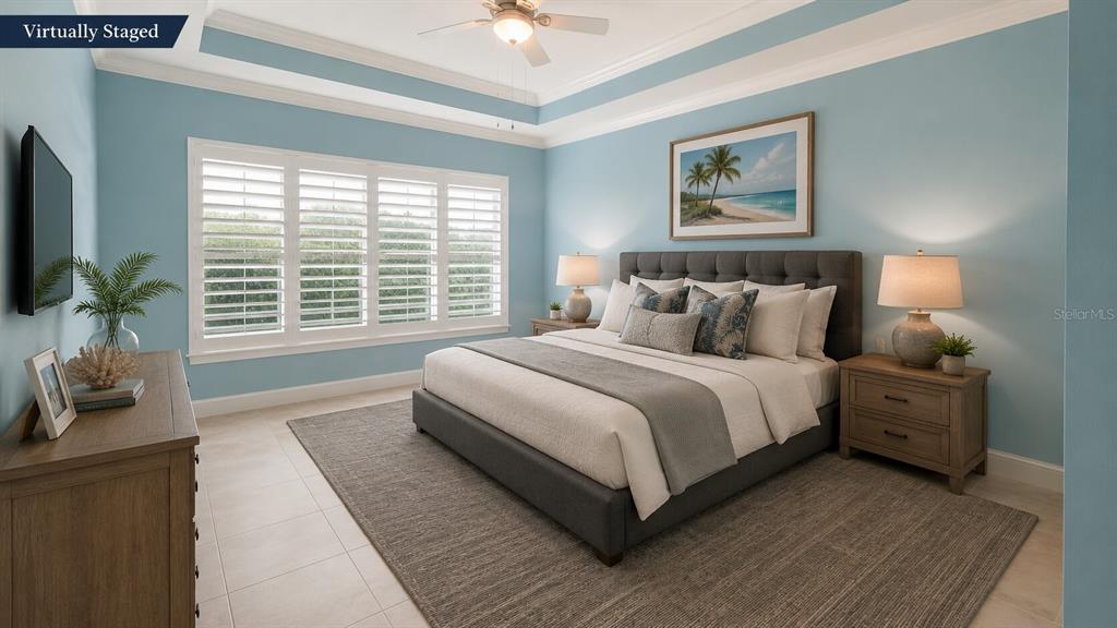 This virtually staged bedroom features light blue walls, a tray ceiling, and a king-sized bed — 17 WATCHTOWER DRIVE, ORMOND BEACH, FL