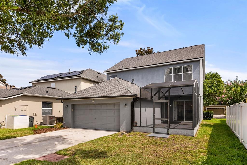 A two-story gray house with a two-car garage and a screened-in back patio — 5032 BEACH RIVER ROAD, WINDERMERE, FL