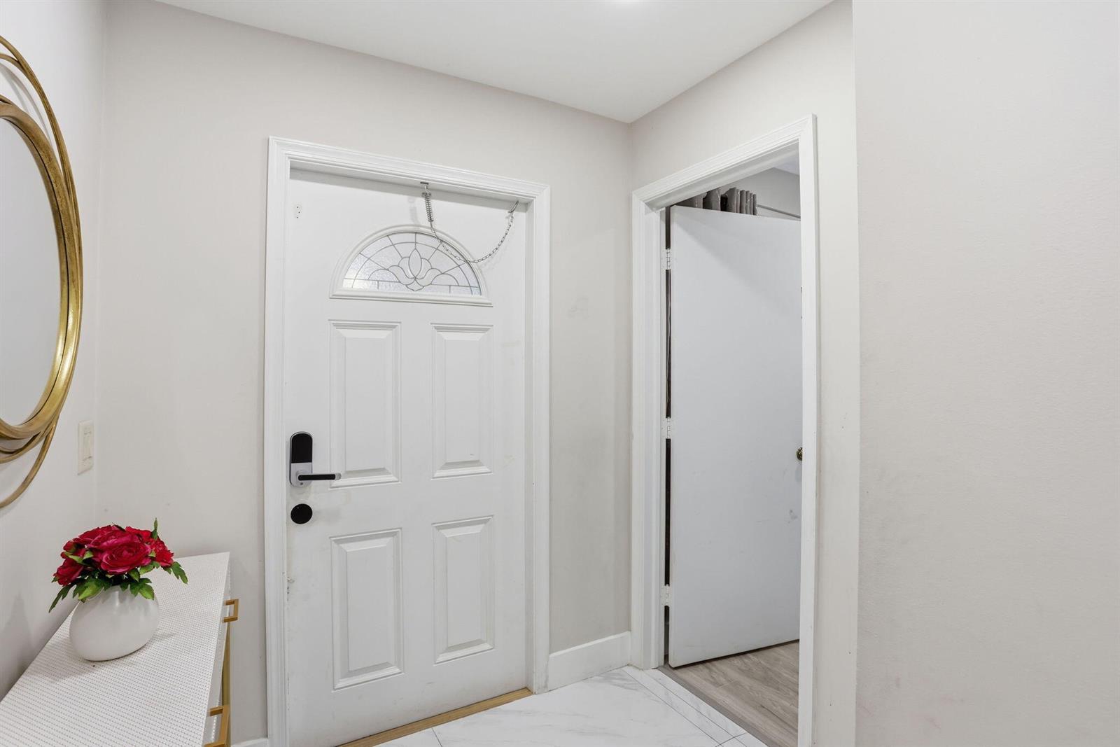 A wet bar features white cabinets, a marble countertop, and a blue geometric wallpaper backsplash — 23451 SW 55th Avenue # B, Boca Raton FL 33433, BOCA RATON, FL
