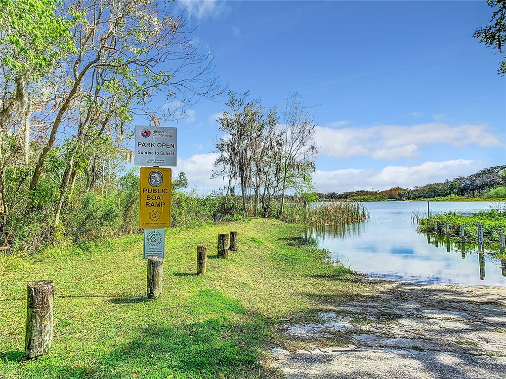 A public boat ramp at a Hillsborough County park with signage and a grassy shoreline — TIGHE STREET, SEFFNER, FL