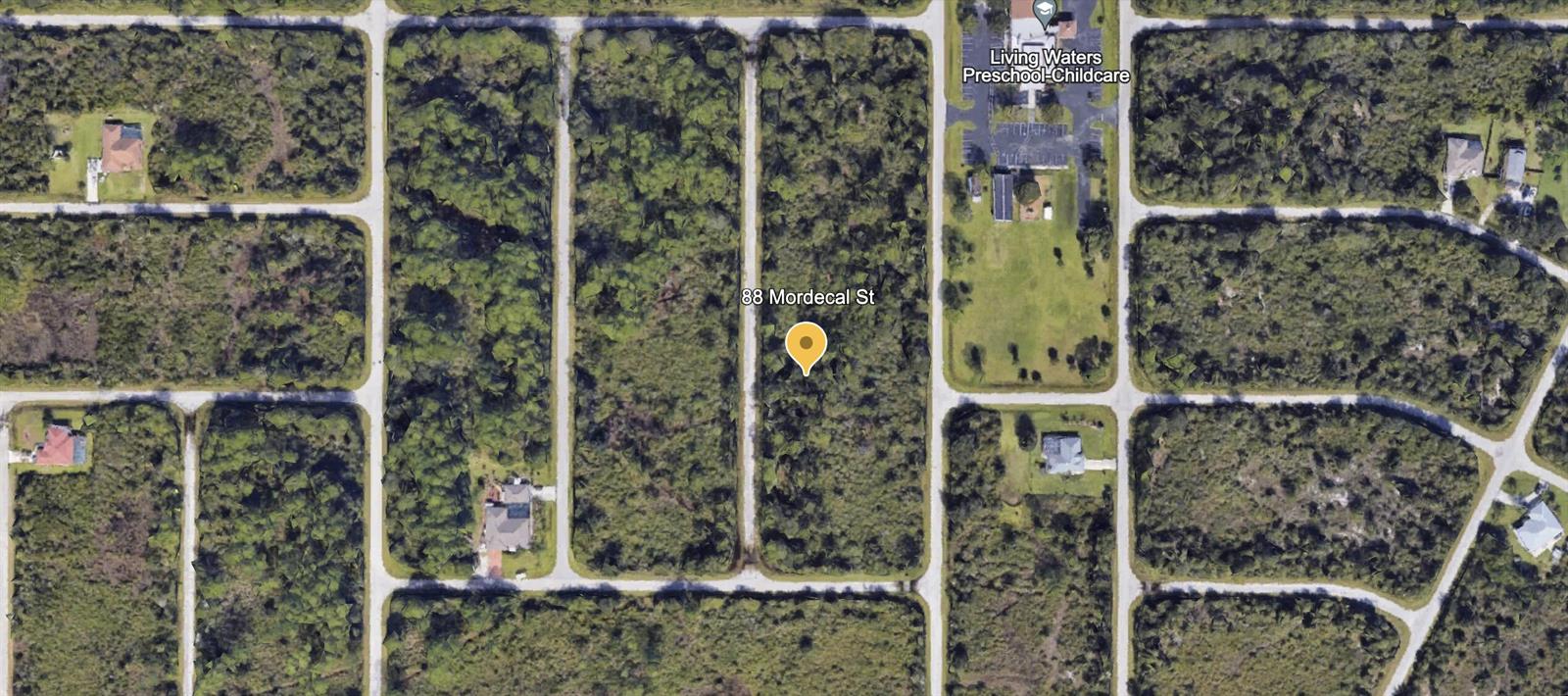 This is an aerial map view of a vacant, wooded residential lot — 88 Mordecal Street, FL 33953, FL