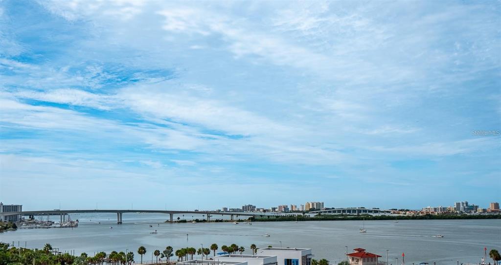 A high-angle view shows a body of water with two bridges and distant buildings — 920 N OSCEOLA AVENUE UNIT 801, CLEARWATER, FL