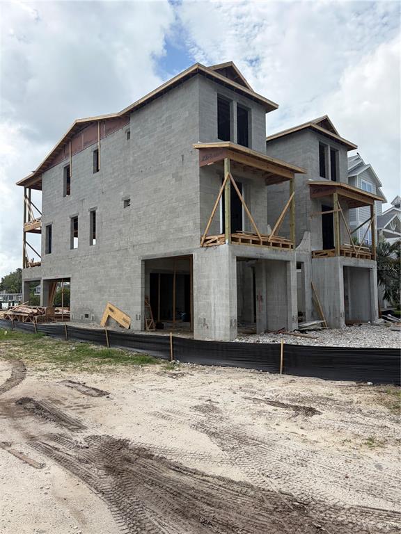 A multi-story concrete block residential building under construction with open porches and framing — 1213 BAY SHORE BOULEVARD, INDIAN ROCKS BEACH, FL