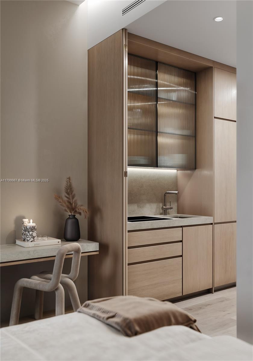 This rendering shows a modern kitchenette with light wood cabinetry, ribbed glass doors, and a desk — 1265 SW 22nd St # 507, Miami FL 33145, MIAMI, FL