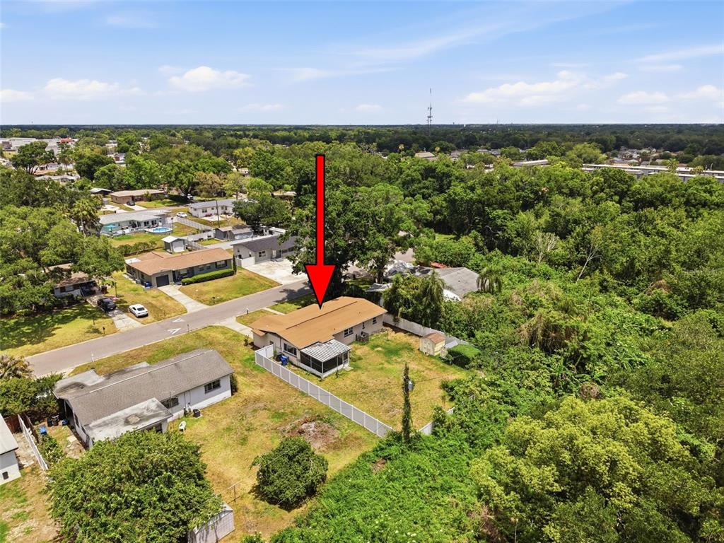 An aerial view shows a single-story house with a brown roof and a screened porch — 2518 W NORTH STREET, TAMPA, FL