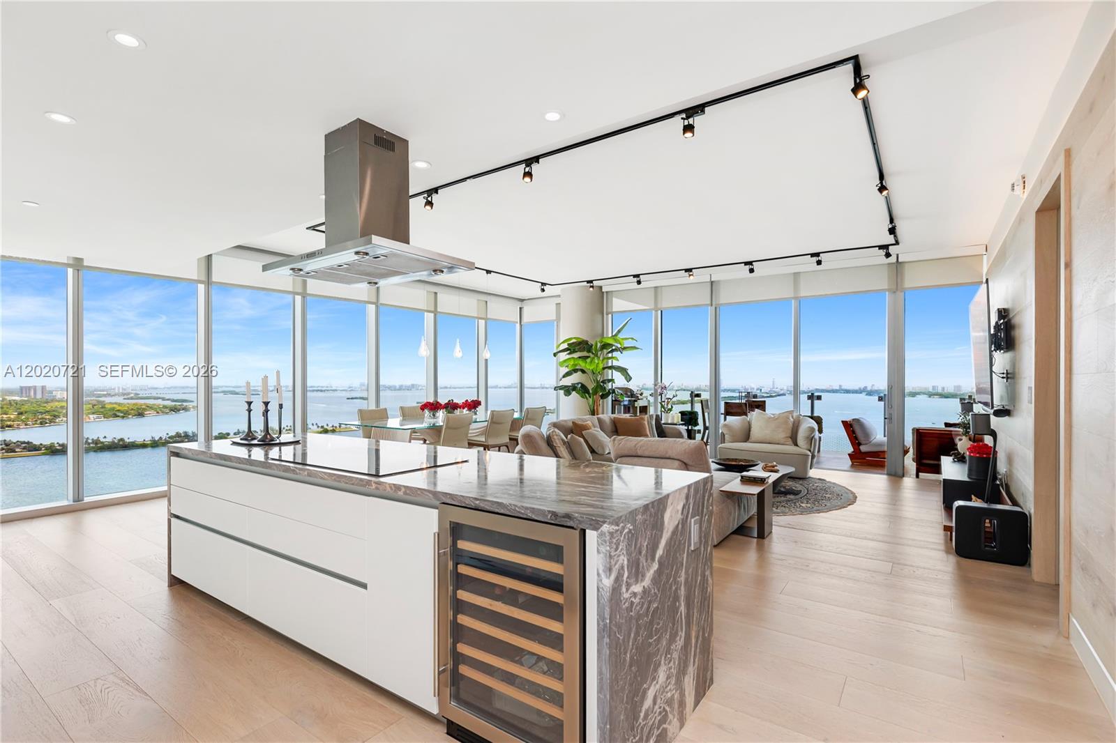 A modern open-concept kitchen and living area features a marble island with a wine cooler — 700 NE 26th Ter # 2901, Miami FL 33137, MIAMI, FL