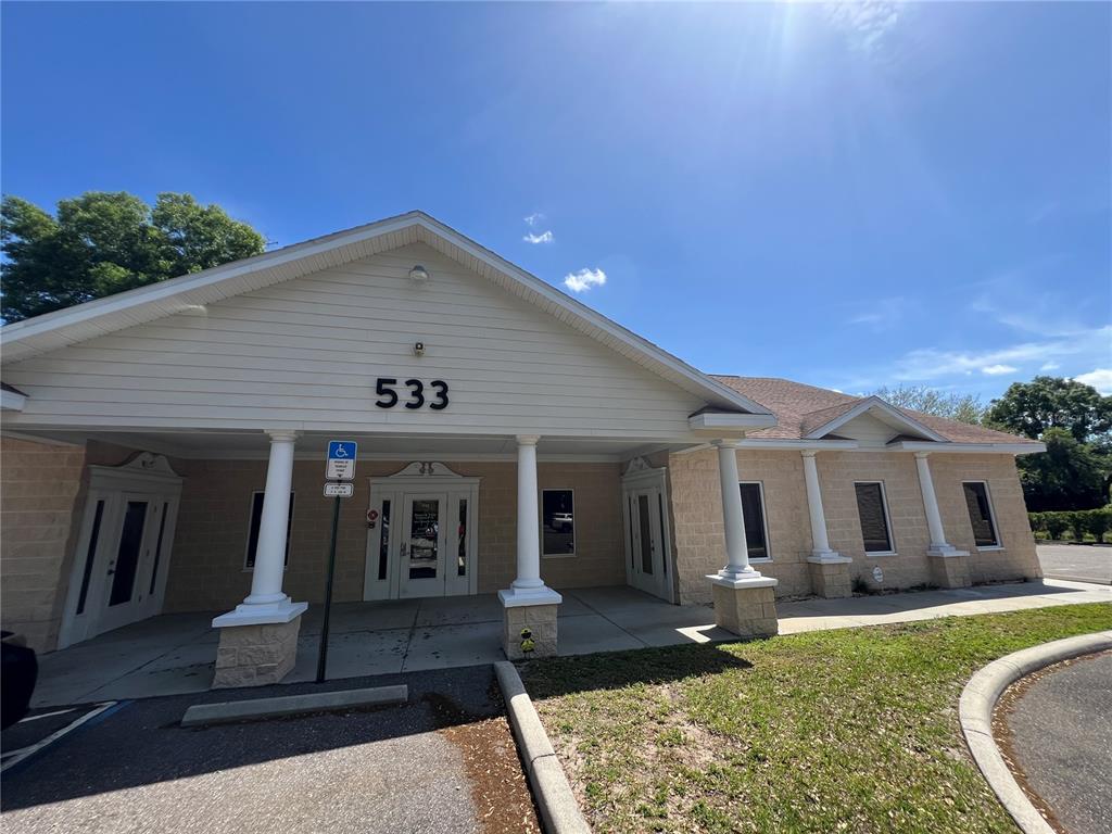 A single-story building with a light-colored facade, white columns, and a covered entrance — 533 MEDICAL OAKS AVENUE UNIT 3, BRANDON, FL