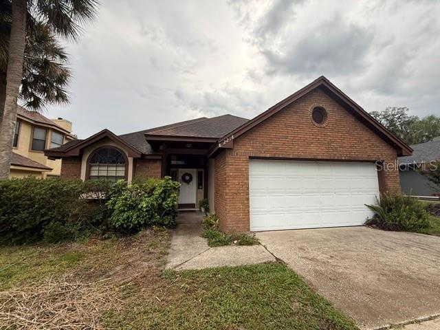 A single-story brick house features a two-car garage and a front entrance with a wreath — 2218 BARKWOOD COURT, LAKE MARY, FL