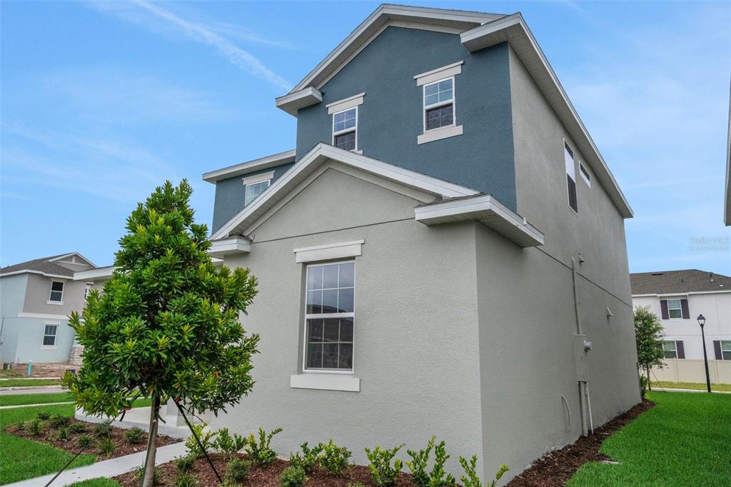 A two-story house with a blue and light gray exterior and a small front yard — 5137 BLANKET FLOWER STREET, APOPKA, FL