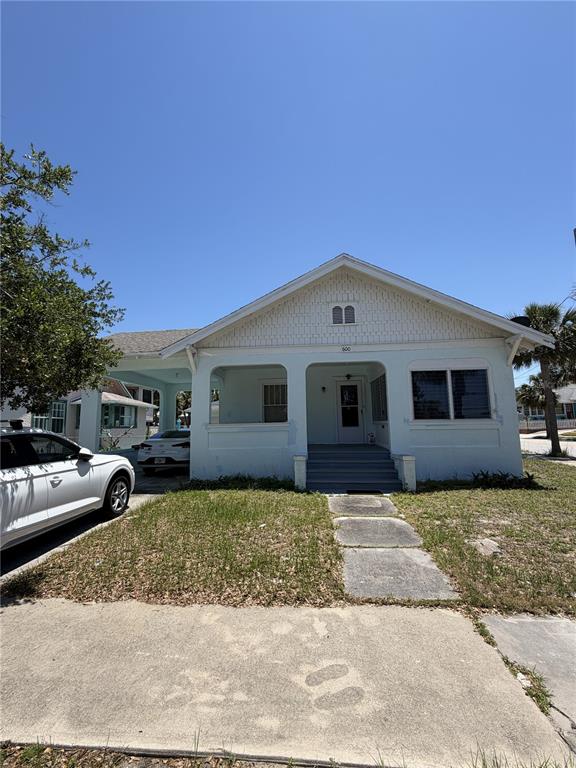 A light blue single-story house with a front porch and an attached carport — 600 5TH AVENUE, DAYTONA BEACH, FL
