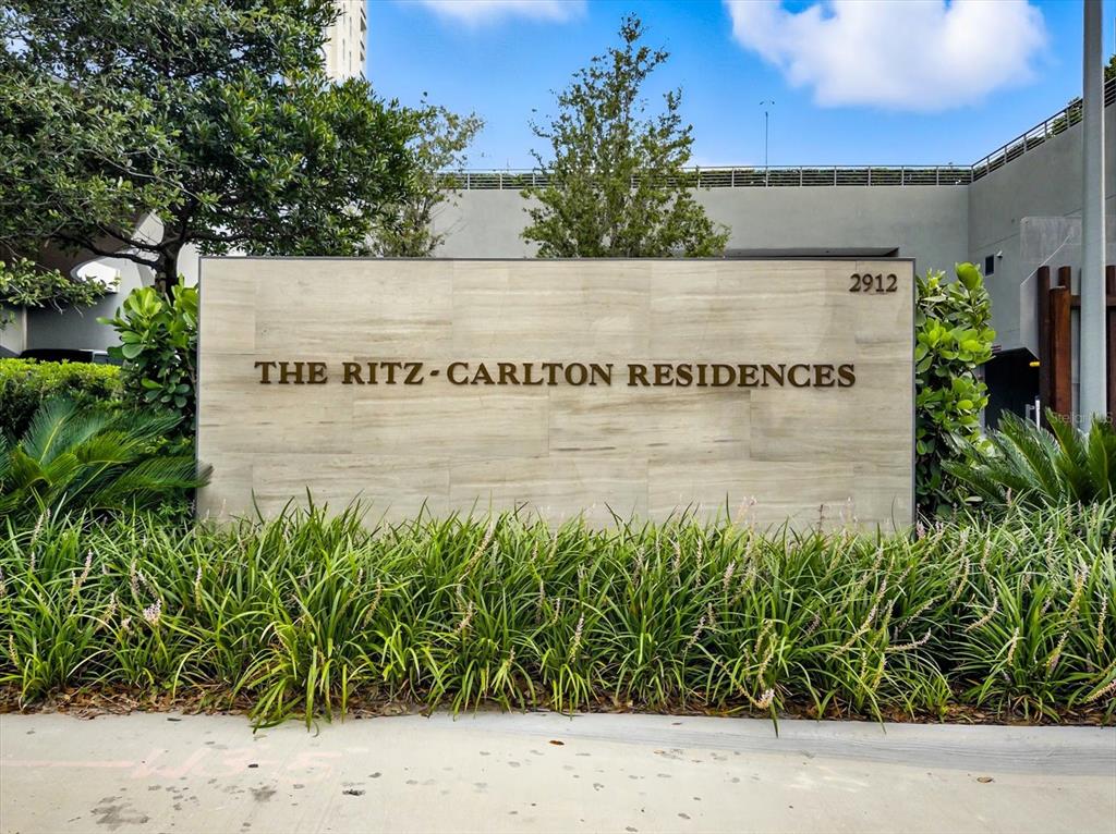 A stone sign for The Ritz-Carlton Residences stands surrounded by lush green landscaping — 3101 BAYSHORE BOULEVARD UNIT 504, TAMPA, FL