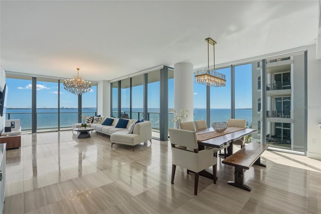 A modern living and dining area with floor-to-ceiling windows overlooking the ocean — 3101 BAYSHORE BOULEVARD UNIT 504, TAMPA, FL