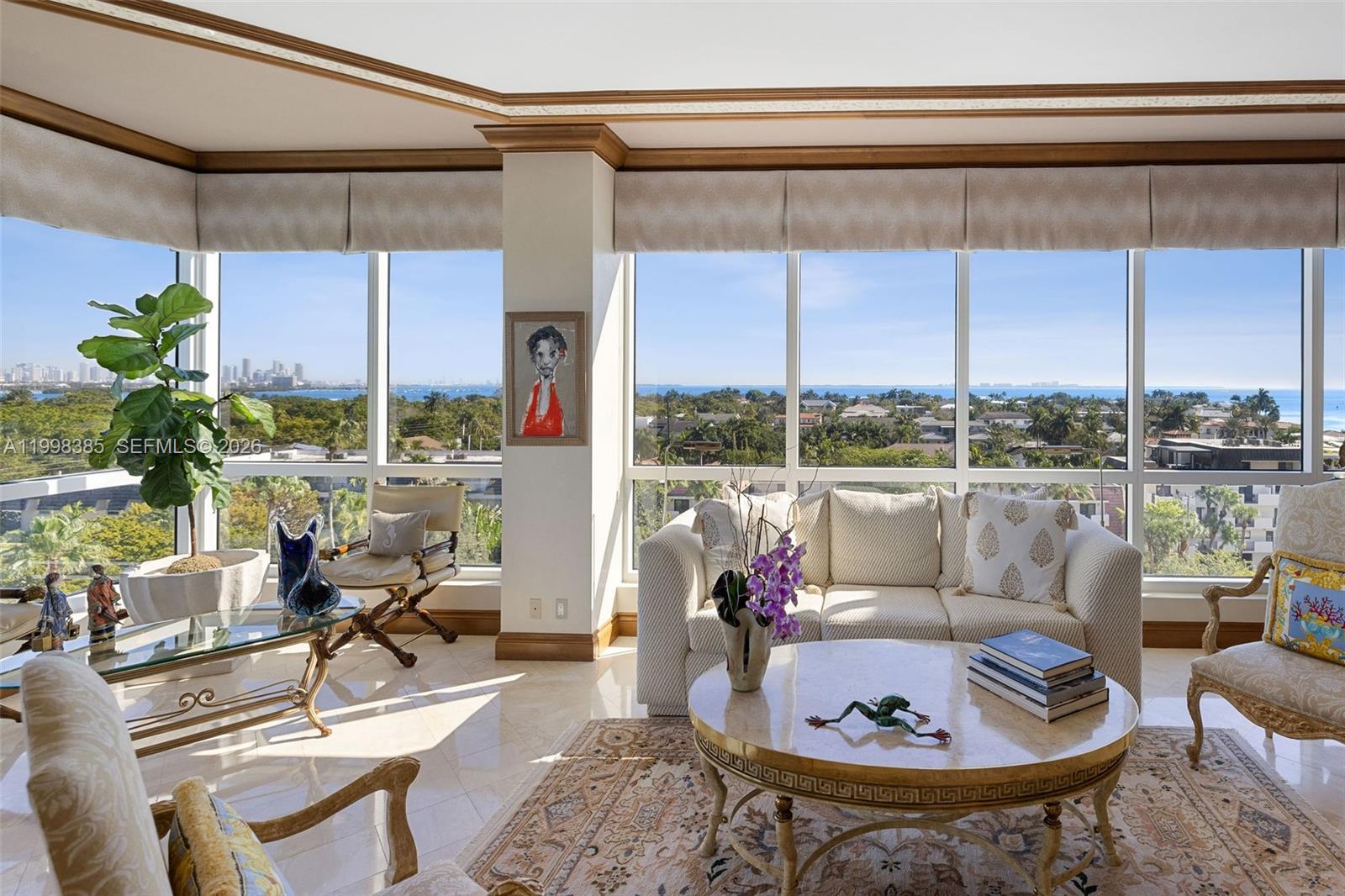 A sunlit living room features floor-to-ceiling windows with panoramic ocean and city views — 10 Edgewater Dr # 7G, Coral Gables FL 33133, CORAL GABLES, FL