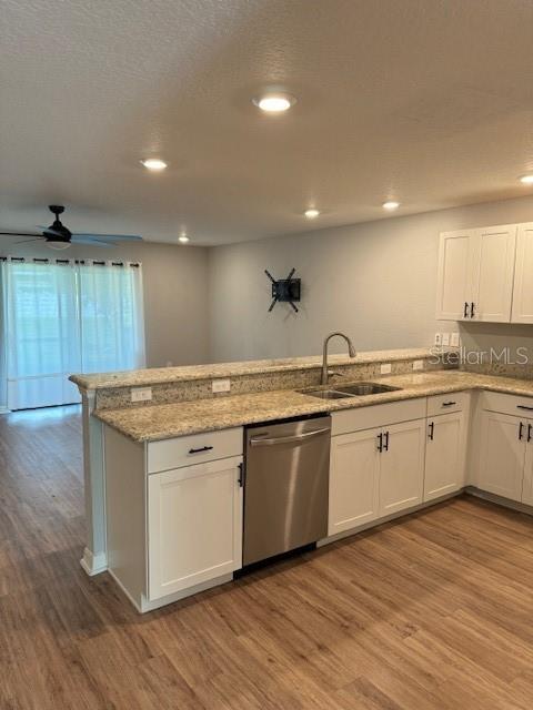 A kitchen with white cabinets, granite countertops, and stainless steel appliances overlooks a living area — 3071 FIELDWOOD CIRCLE, ST CLOUD, FL