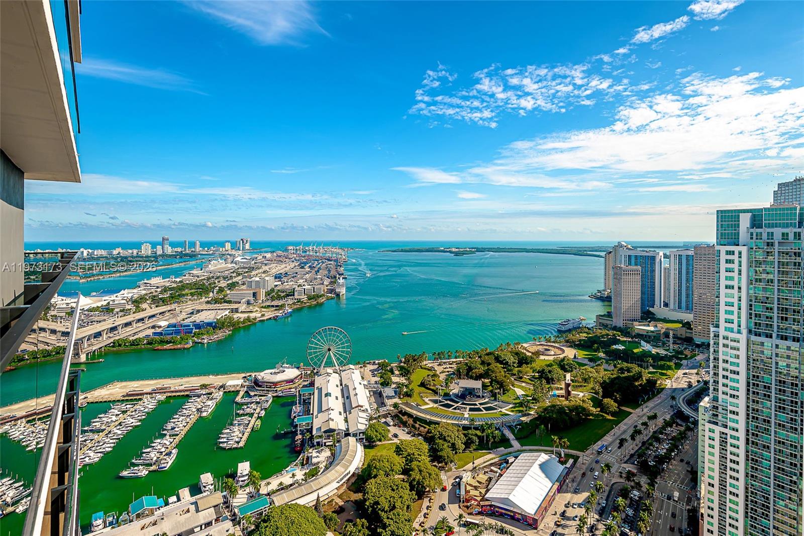 An elevated view of the Miami waterfront, featuring a marina, Ferris wheel, and city skyline — 398 NE 5th St # 4512, Miami FL 33132, MIAMI, FL