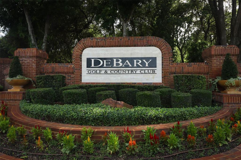 A brick entrance sign for the DeBary Golf & Country Club surrounded by landscaped gardens — 340 HAMPTON HILLS COURT, DEBARY, FL