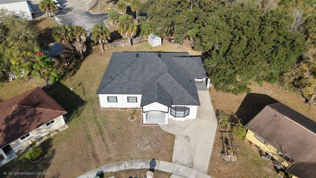 An aerial view shows a white house with a dark roof and a concrete driveway — 5602 CHARLES DRIVE, TAMPA, FL