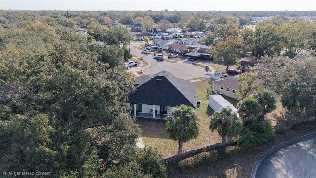 An aerial view shows a house with a dark roof and a large backyard — 5602 CHARLES DRIVE, TAMPA, FL