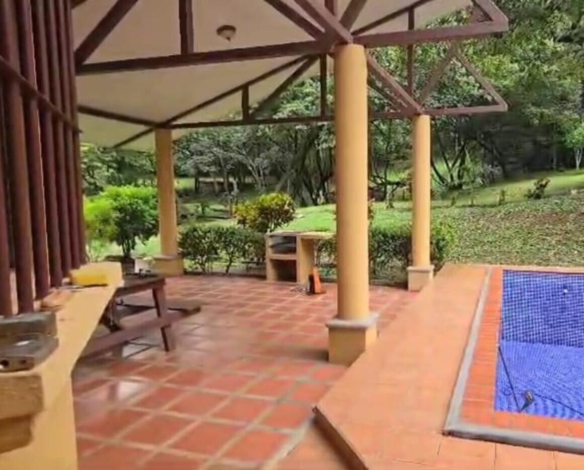 A covered patio with terracotta tile flooring overlooks a swimming pool and a grassy yard — De Estación Bomberos 1km Norte 3km Al Oeste, FL