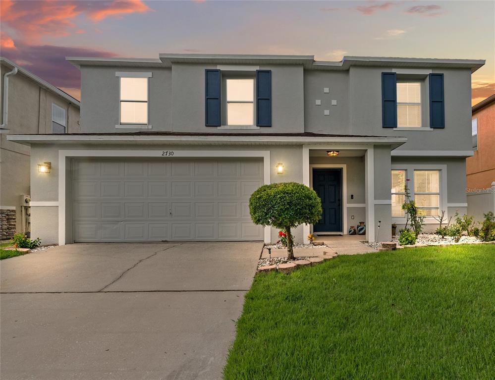 A two-story house with a gray exterior, a two-car garage, and a front lawn — 2730 AMANDA KAY WAY, KISSIMMEE, FL