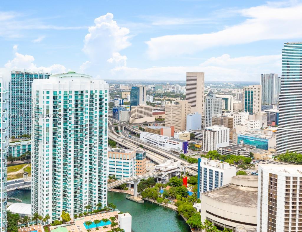 An aerial view of a dense city skyline featuring high-rise buildings and a river — 485 Brickell Ave # 4307, Miami FL 33131, MIAMI, FL
