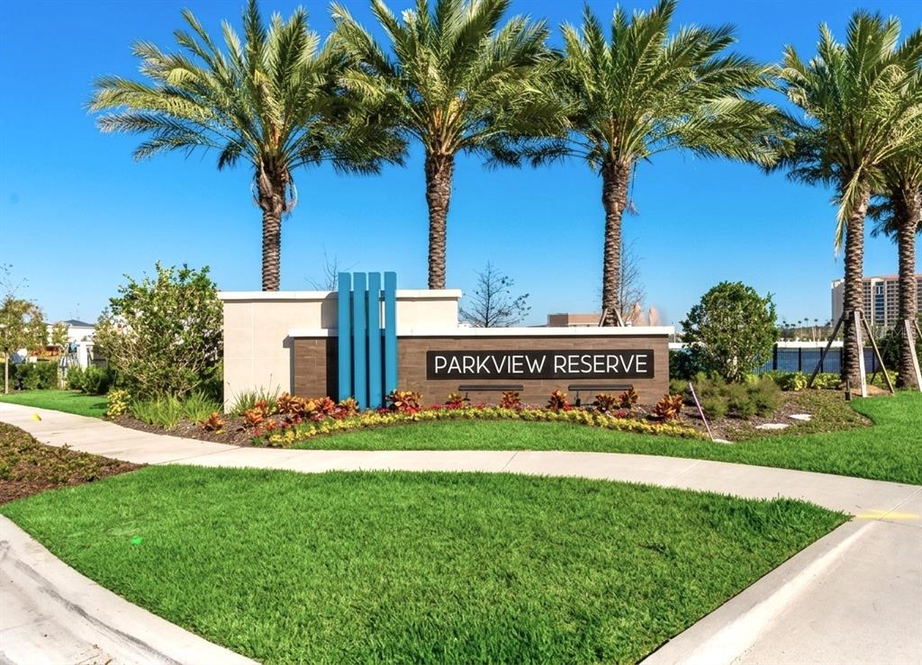 A stone and wood monument sign for Parkview Reserve stands before several tall palm trees — 8322 PARK CLIFF WAY, ORLANDO, FL