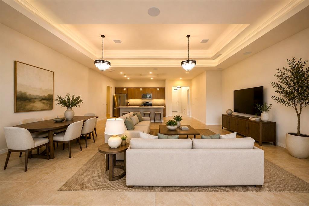 An open-concept living, dining, and kitchen area with a tray ceiling and tile flooring — 8322 PARK CLIFF WAY, ORLANDO, FL