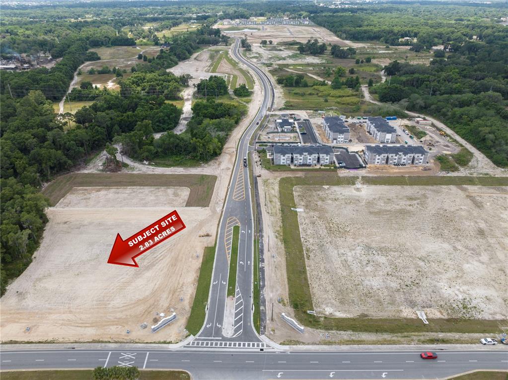 An aerial view shows a vacant 2.83-acre plot of land adjacent to a paved road — NW 35TH STREET, OCALA, FL