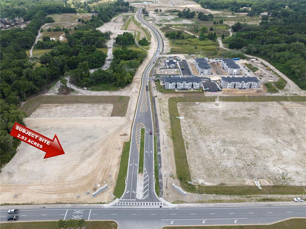 An aerial view shows a vacant 2.83-acre lot next to a road and apartment buildings — NW 35TH STREET, OCALA, FL