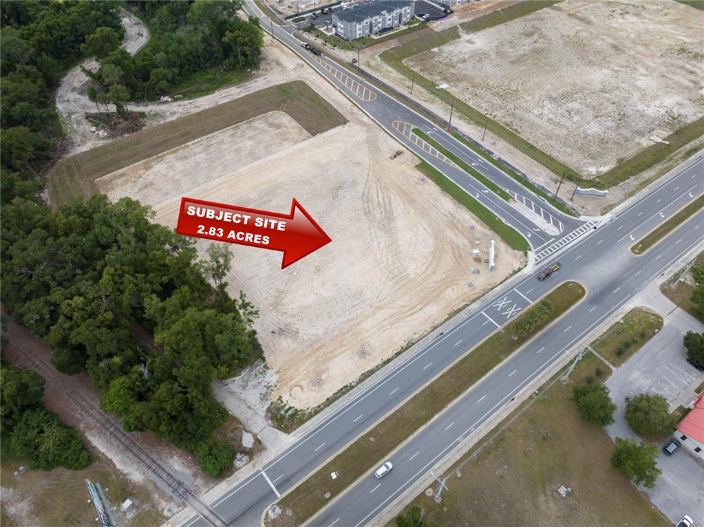An aerial view shows a cleared, vacant 2.83-acre lot situated at a road intersection — NW 35TH STREET, OCALA, FL