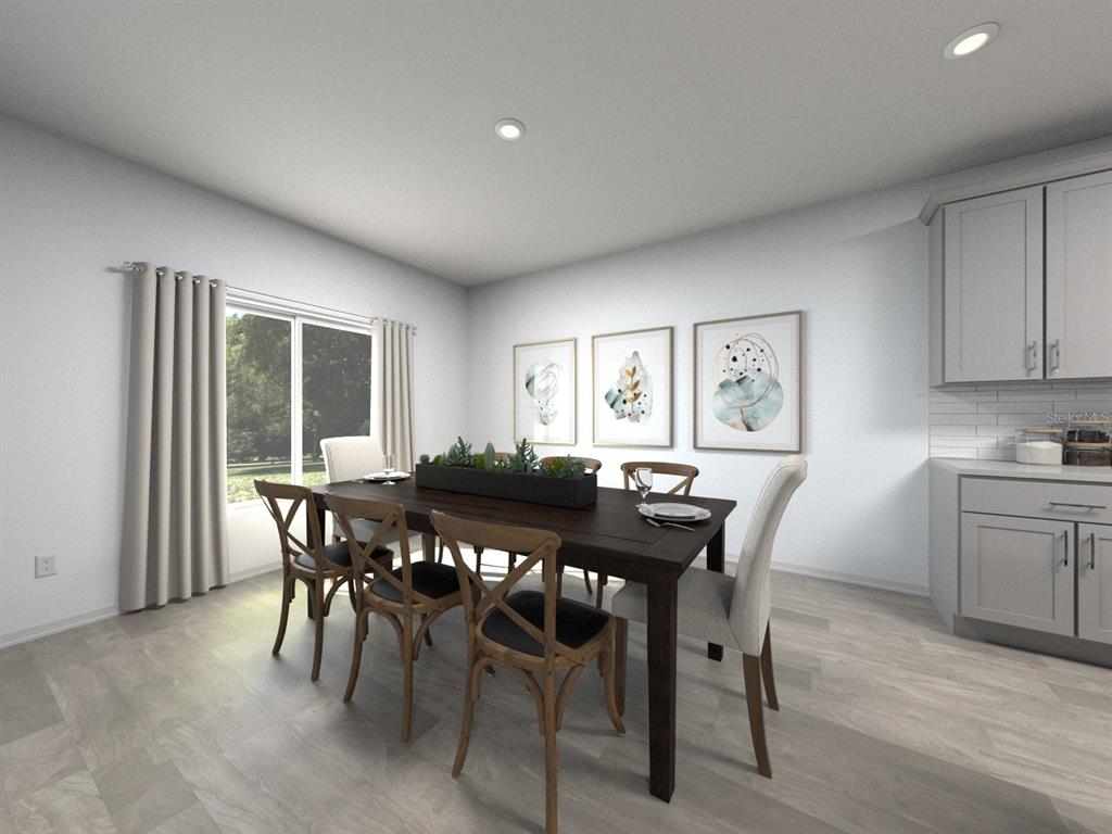 This is a rendering of a dining room with a wooden table, chairs, and wall art — 3317 ORCHARD LOOP, BARTOW, FL