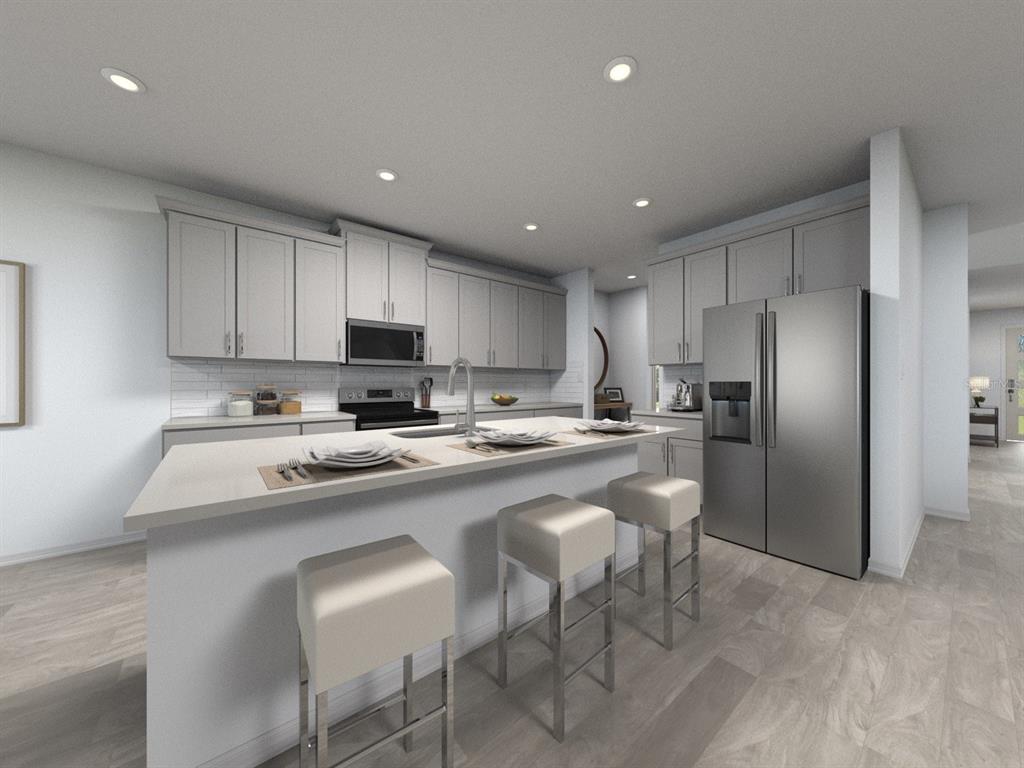 This is a rendering of a modern kitchen featuring gray cabinetry, stainless steel appliances, and an island — 3317 ORCHARD LOOP, BARTOW, FL