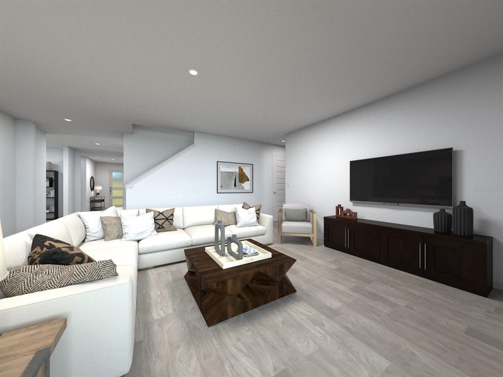 This is a digital rendering of a modern living room with a sectional and television — 3317 ORCHARD LOOP, BARTOW, FL