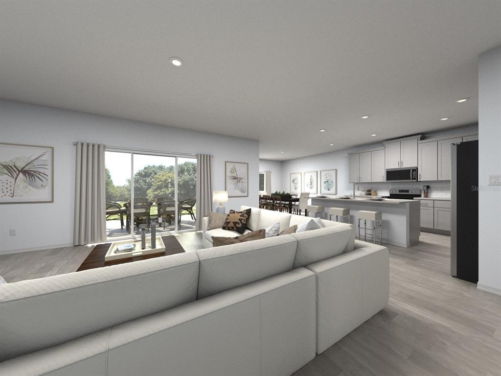 This is a digital rendering of an open-concept living room and kitchen with light flooring — 3317 ORCHARD LOOP, BARTOW, FL