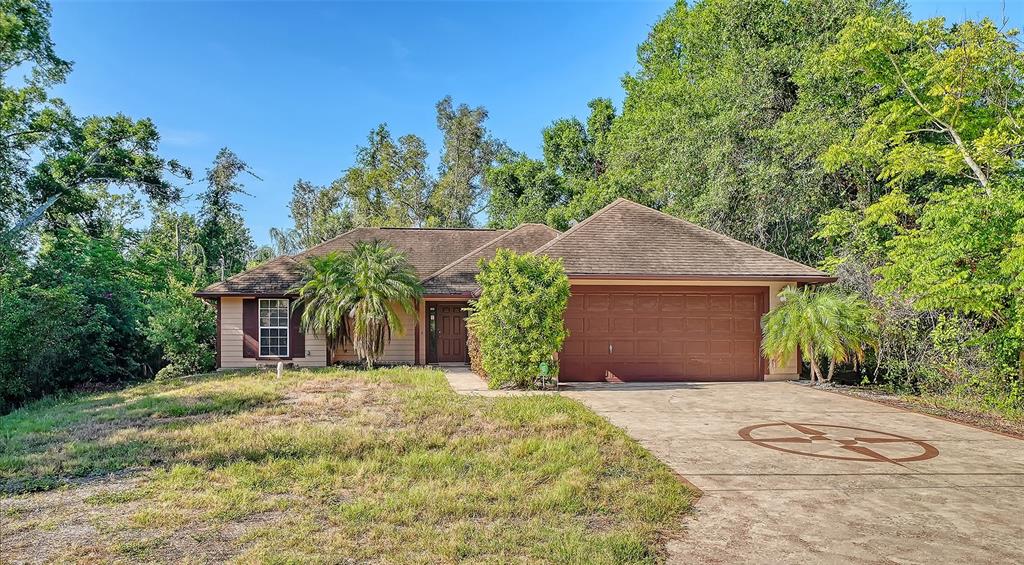 A single-story house with a brown roof, tan siding, and a two-car garage — 2452 ASHTON ROAD, SARASOTA, FL