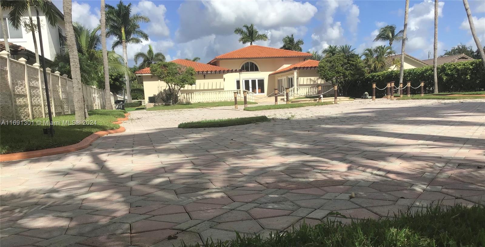 A paved driveway leads to a single-story house with a red tile roof and palm trees — 13460 SW 32nd ST, Kendall FL 33175, KENDALL, FL